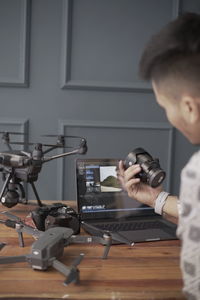 Man photographing with smart phone on table