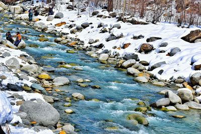 Pebbles on frozen water in winter