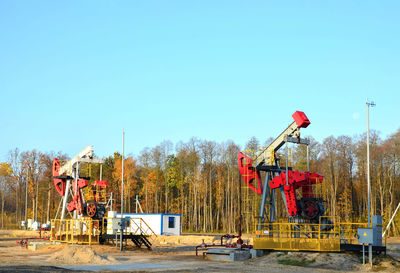 People at construction site against clear sky