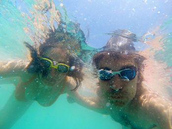 Couple swimming in sea