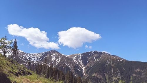 Scenic view of mountains against blue sky