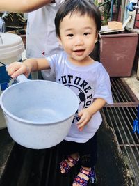 Portrait of cute boy holding ice cream in bowl