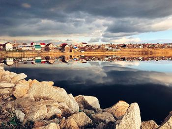 Reflection of rocks in lake against sky