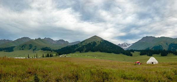 Scenic view of mountains against cloudy sky