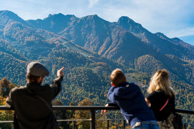 Rear view of people looking at mountains