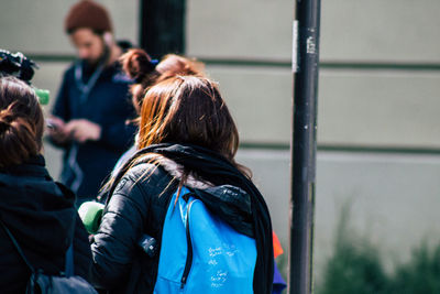 Rear view of people standing outdoors