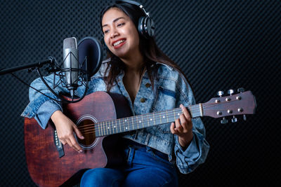 Young woman playing guitar