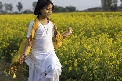 Full length of woman standing on field