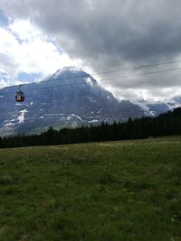 Scenic view of landscape against cloudy sky