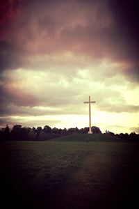 Scenic view of field against cloudy sky