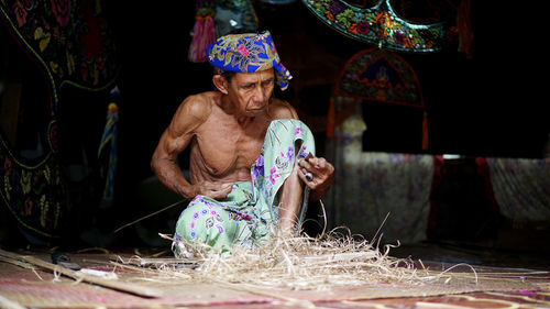 Man working in traditional clothing