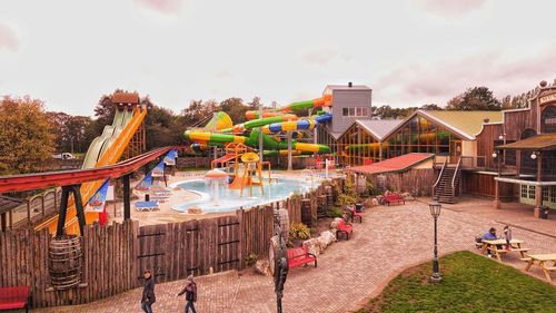 People at playground against buildings