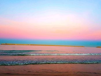 Scenic view of beach against sky during sunset