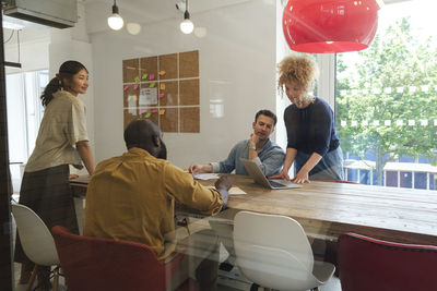 Creative business people having meeting in modern conference room discussing solutions