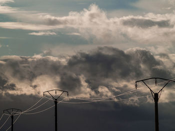 Low angle view of electricity pylon against sky