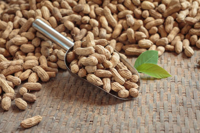 High angle view of peanuts and spatula on table