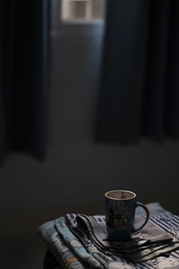 Close-up of coffee cup on table at home