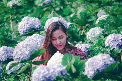 Portrait of beautiful woman with red flower