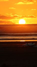 Scenic view of sea against orange sky