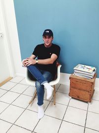 Portrait of young man sitting at home