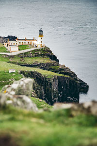 Lighthouse on cliff by sea
