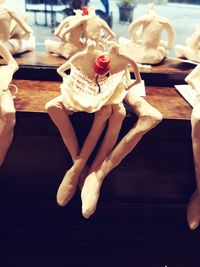 Low section of woman sitting on table