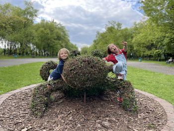 Rear view of kids standing amidst plants