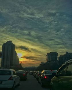 Cars on road at sunset