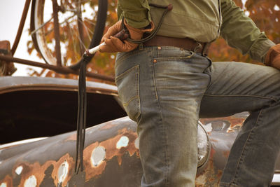 Midsection of man holding leather