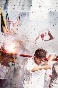 Close-up of woman standing against white background