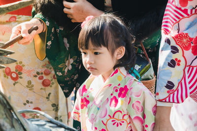 High angle view of girl in kimono standing outdoors