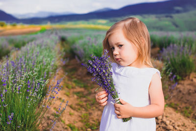 Cute girl standing on field