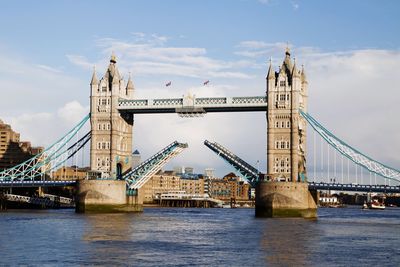 Tower bridge over thames river against sky