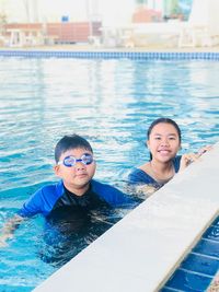 Portrait of happy boy swimming in pool