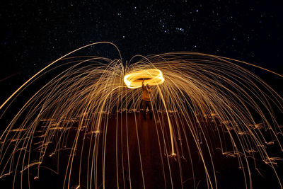 Low angle view of firework display at night