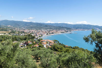 High angle view of city by sea against sky