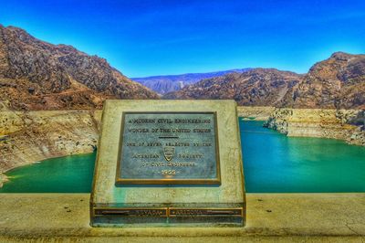 Scenic view of mountains against blue sky