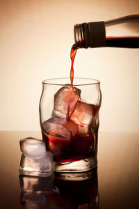 Close-up of drink pouring in glass