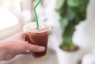 Close-up of hand holding coffee cup
