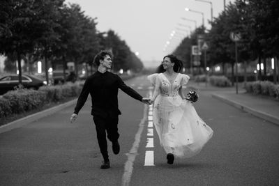 Rear view of woman walking on road