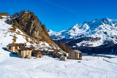 View of the village of grevasalvas, and lake sils, in engadine, switzerland, in winter.