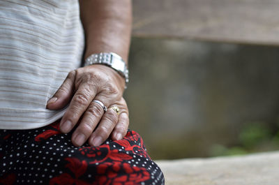 Midsection of couple holding hands