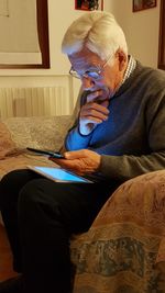 Midsection of man sitting at home