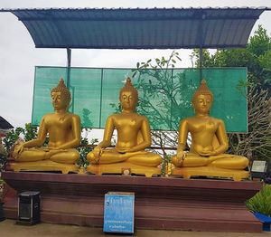 Sculpture of buddha statue in temple outside building