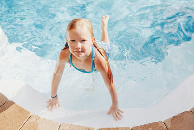 High angle portrait of girl in swimming pool