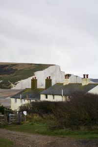 Houses on field against sky