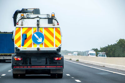 Vehicles on road against sky