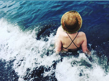 High angle view of man splashing water in sea