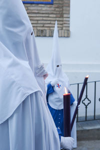 Midsection of people standing on cross