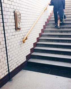 Low section of woman walking on stairs